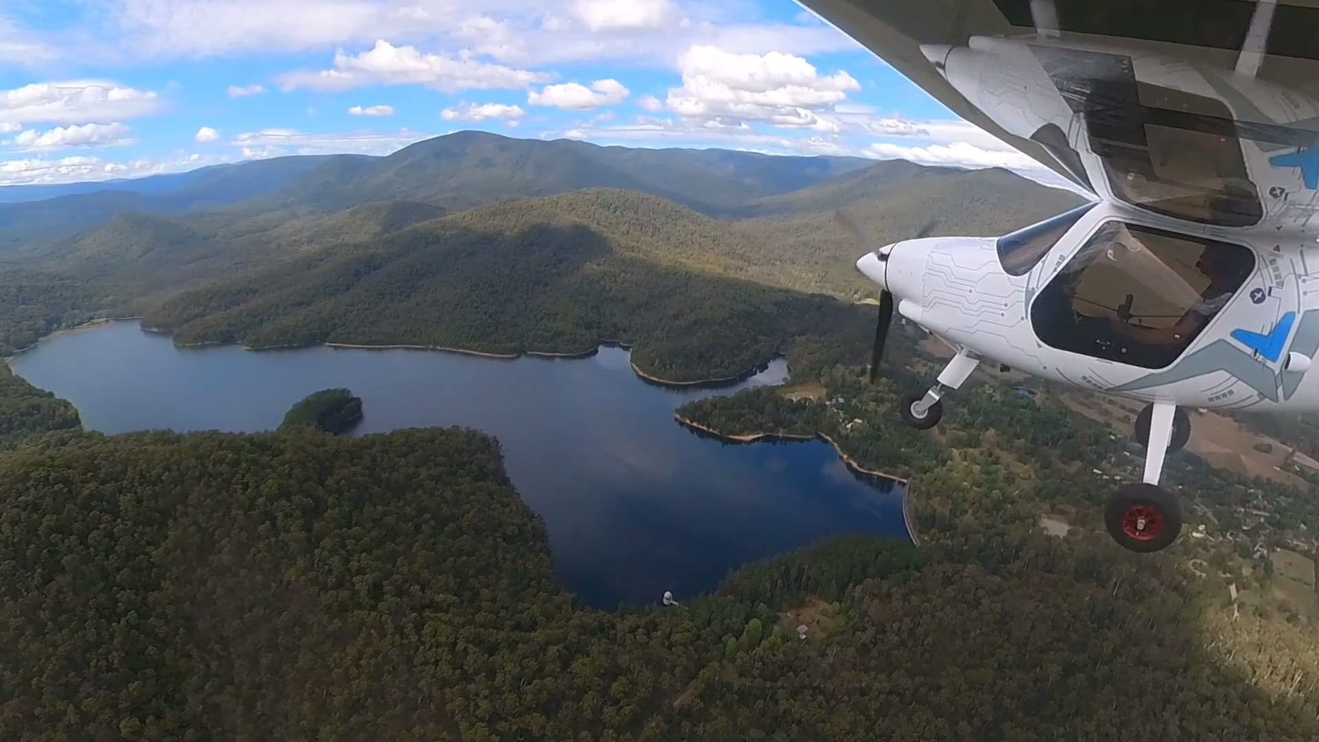 Pipistrel Alpha Electro flying over a reservoir near Healesville in Victoria