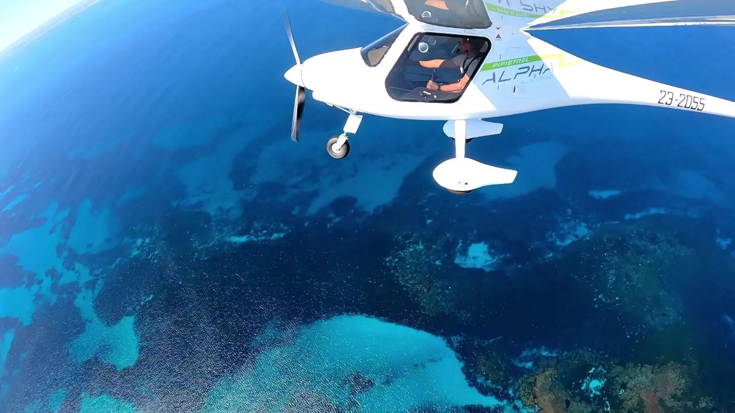 PIpistrel Alpha Electro electric aircraft flying over Rottnest Island Reefs
